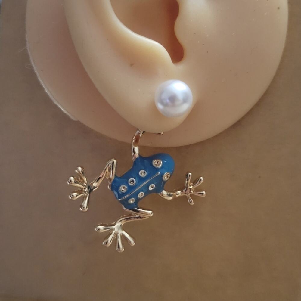 Adorable blue enamel & gold tone frog earrings hanging from synthetic pearl
